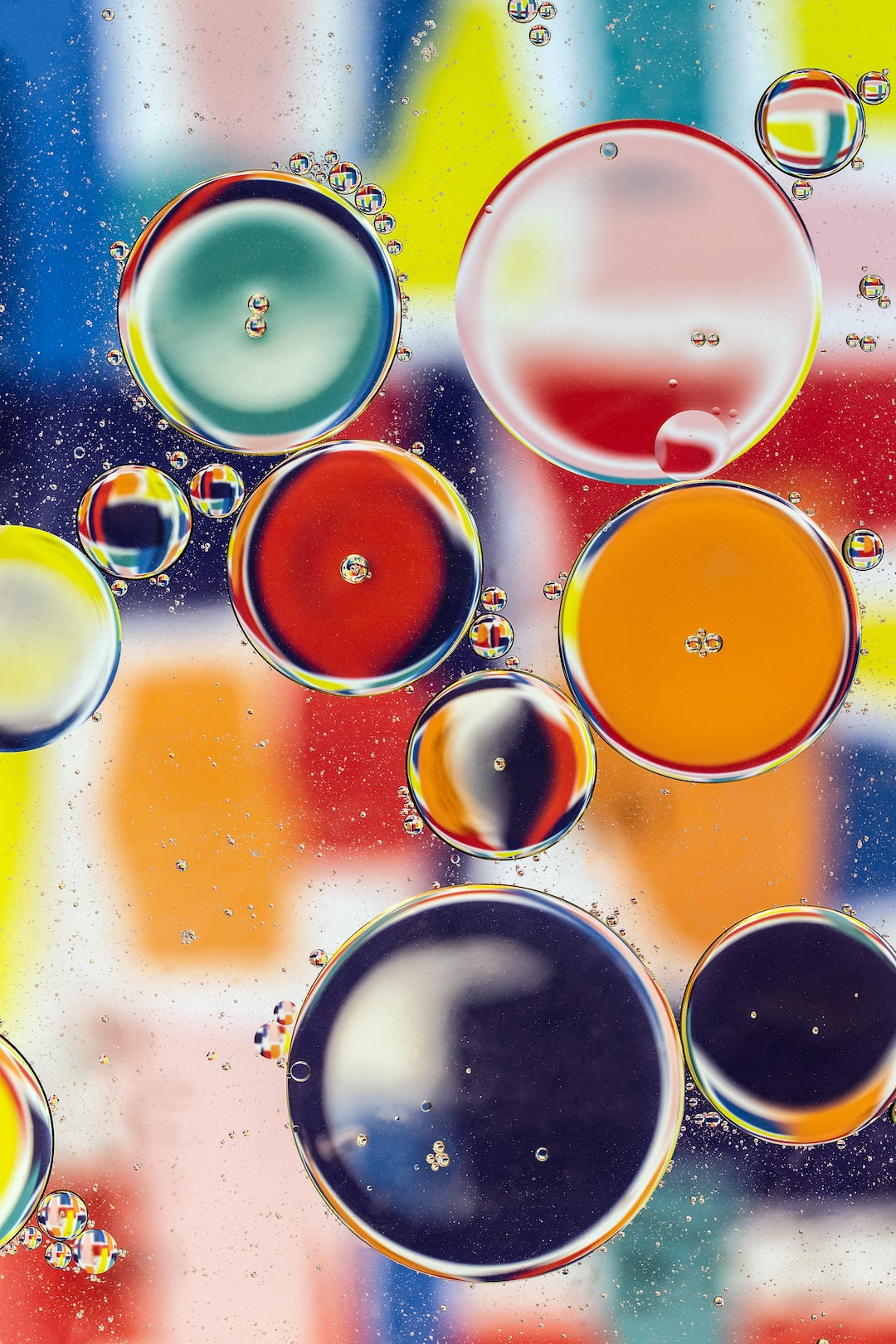 Abstract oil drops. Oil drops floating above an abstract artwork. This image should suit large canvas prints and also work as phone wallpaper.