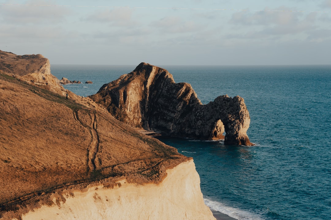 Durdle Door surrounded by a blue sea at sunset