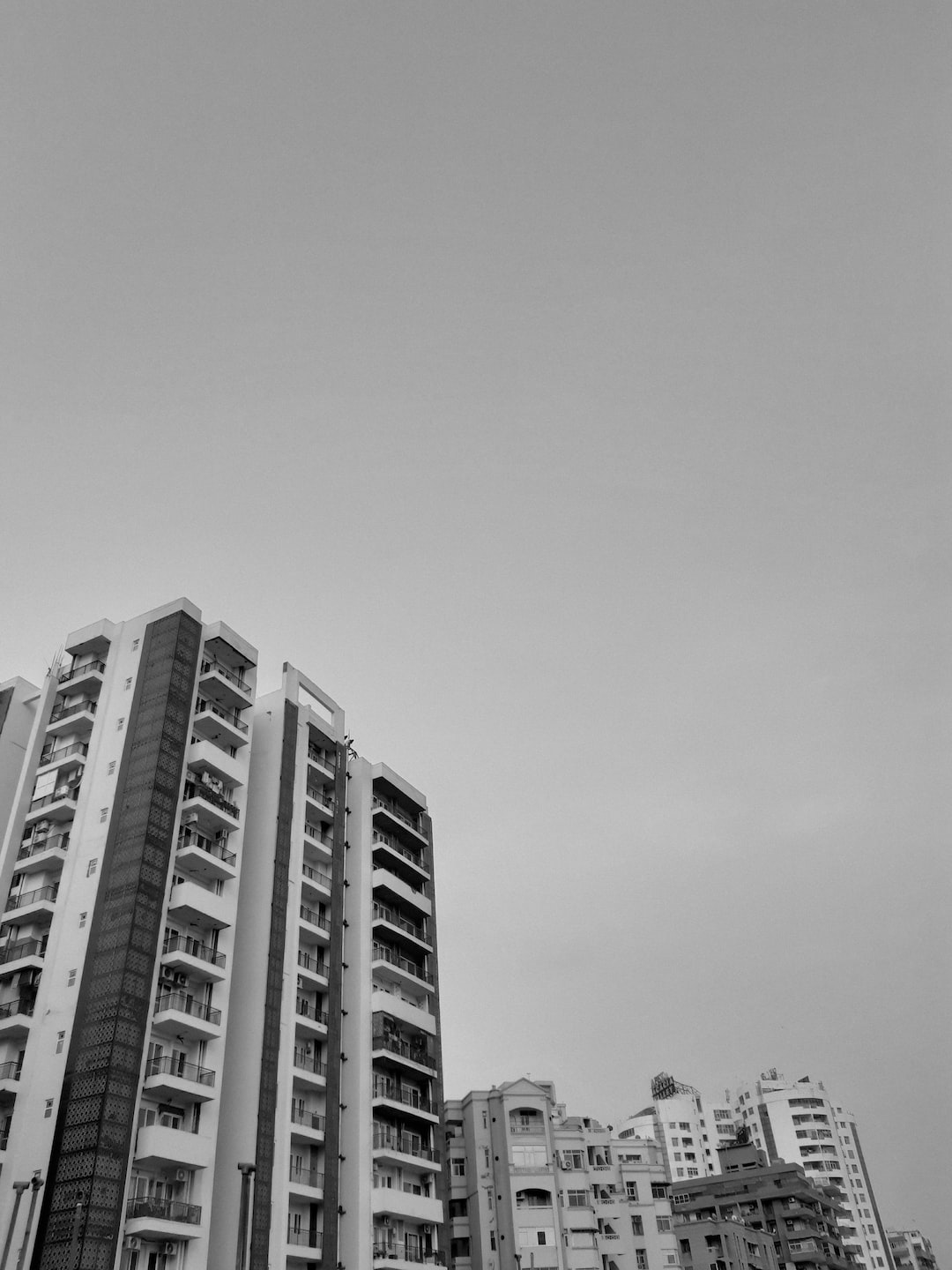 A black and white shot of buildings - apartments.