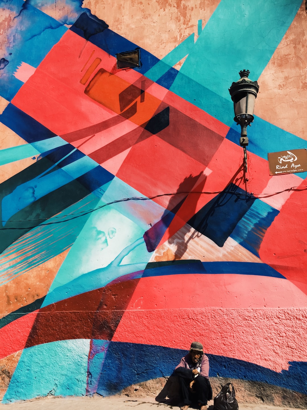 Man in front of abstract mural