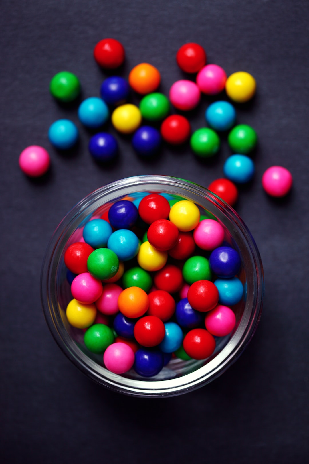 A bowl of colorful candy gumballs.