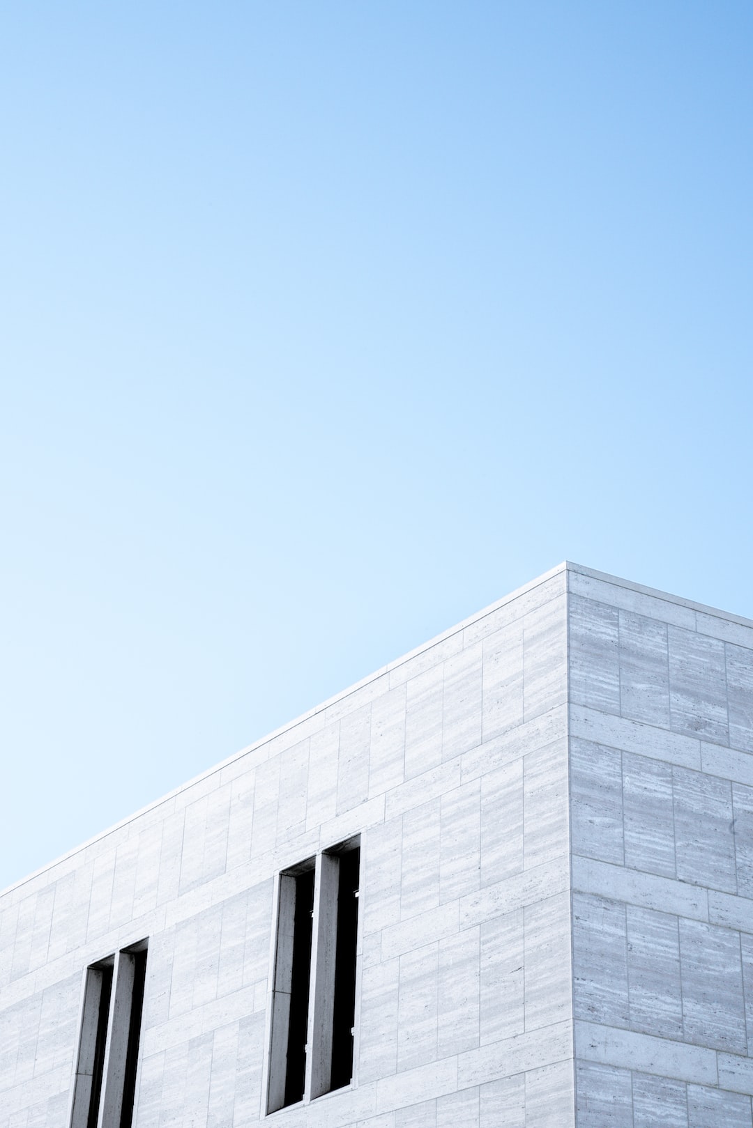 Clean exterior of a modern stone building.