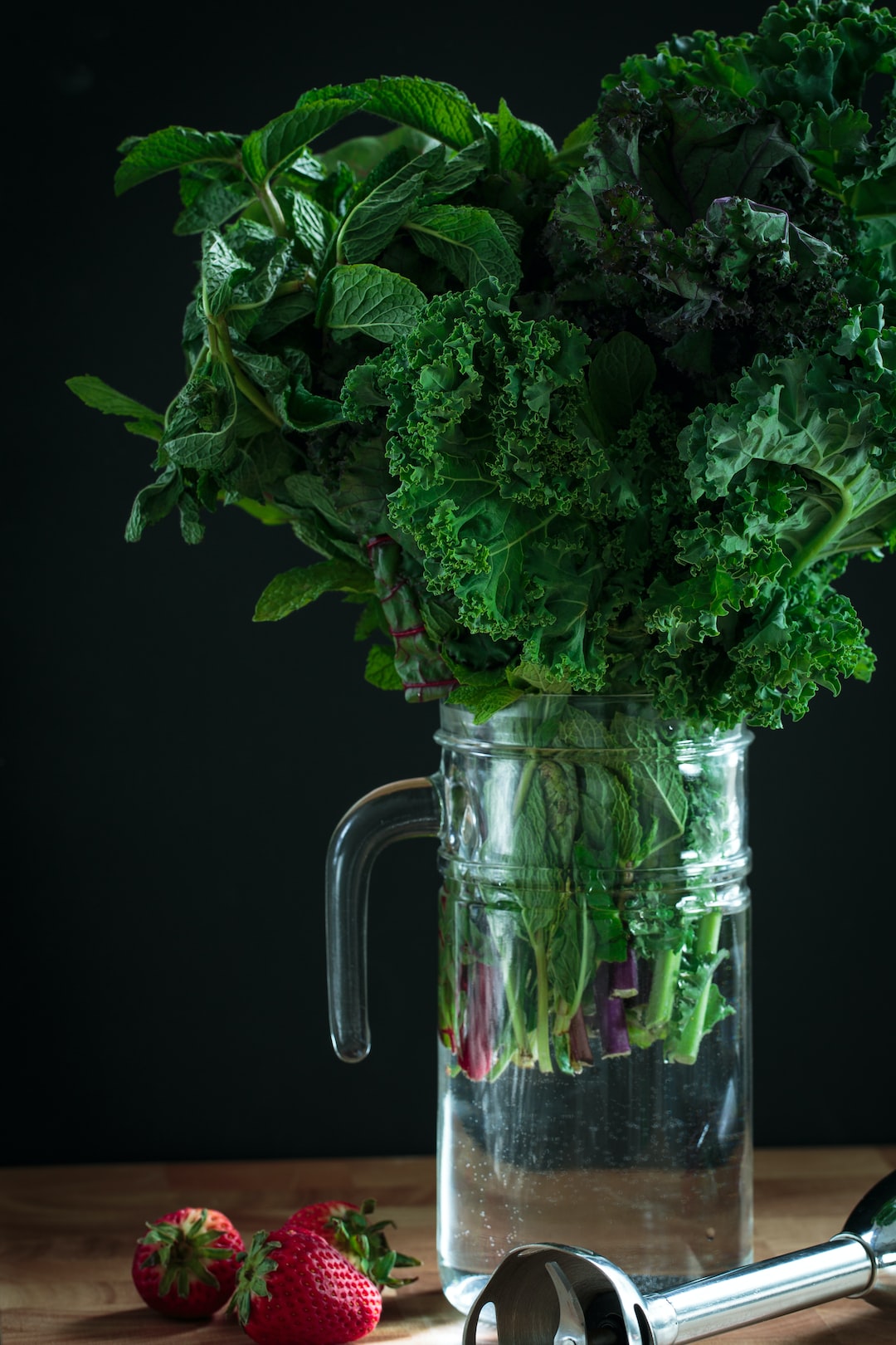 A bouquet of greens—organic green, red and black kale, organic mint, and red chard—make a unique center piece before becoming a healthy smoothie.