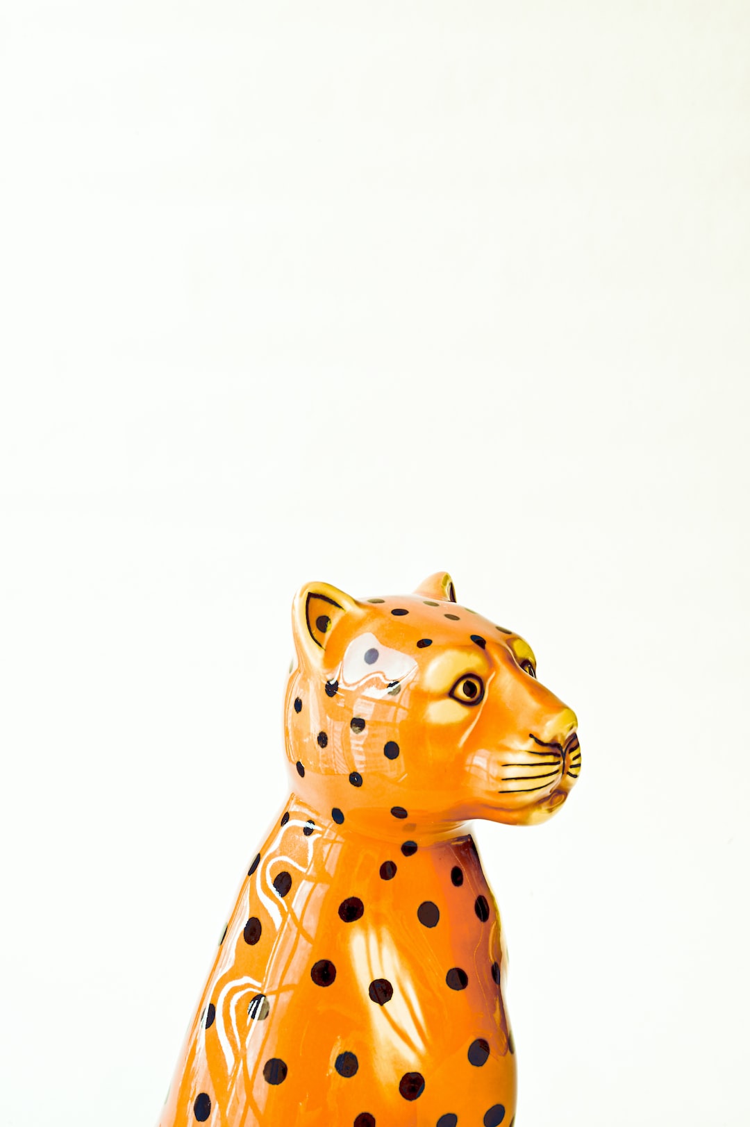 Leopard ceramic sculpture on white background