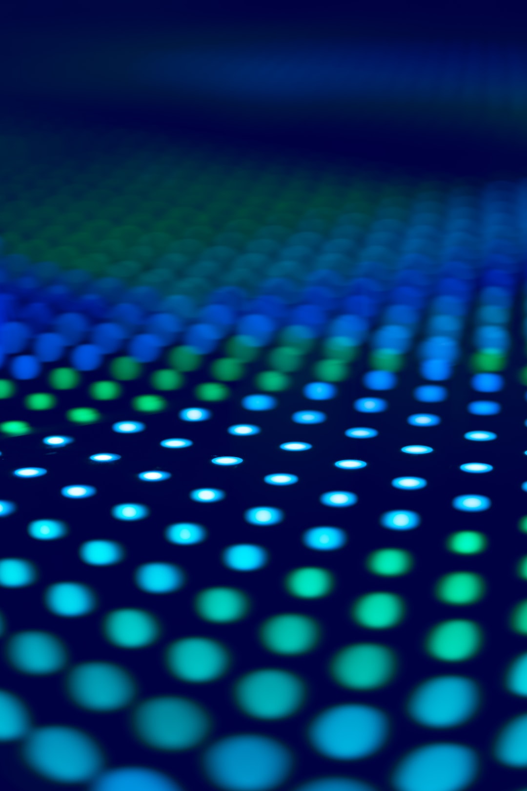 Shallow depth of field photo of an LED dance floor.