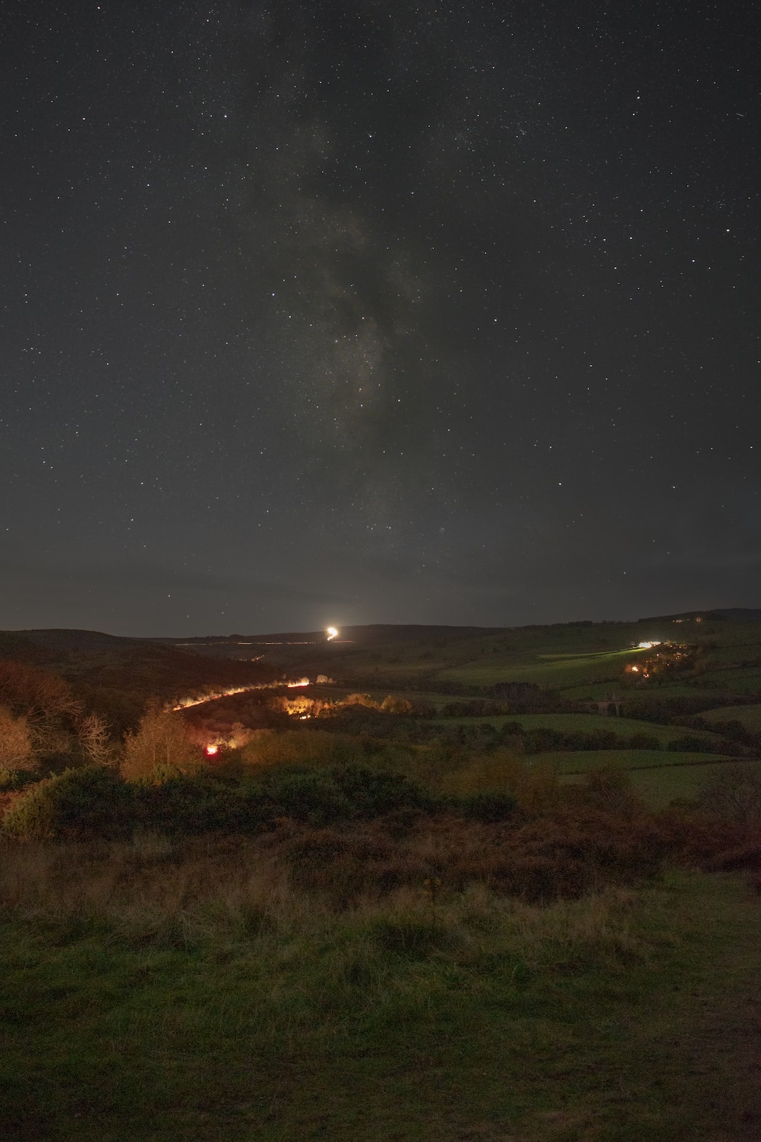 Milky Way Core rising high above a beautiful rolling fields landscape