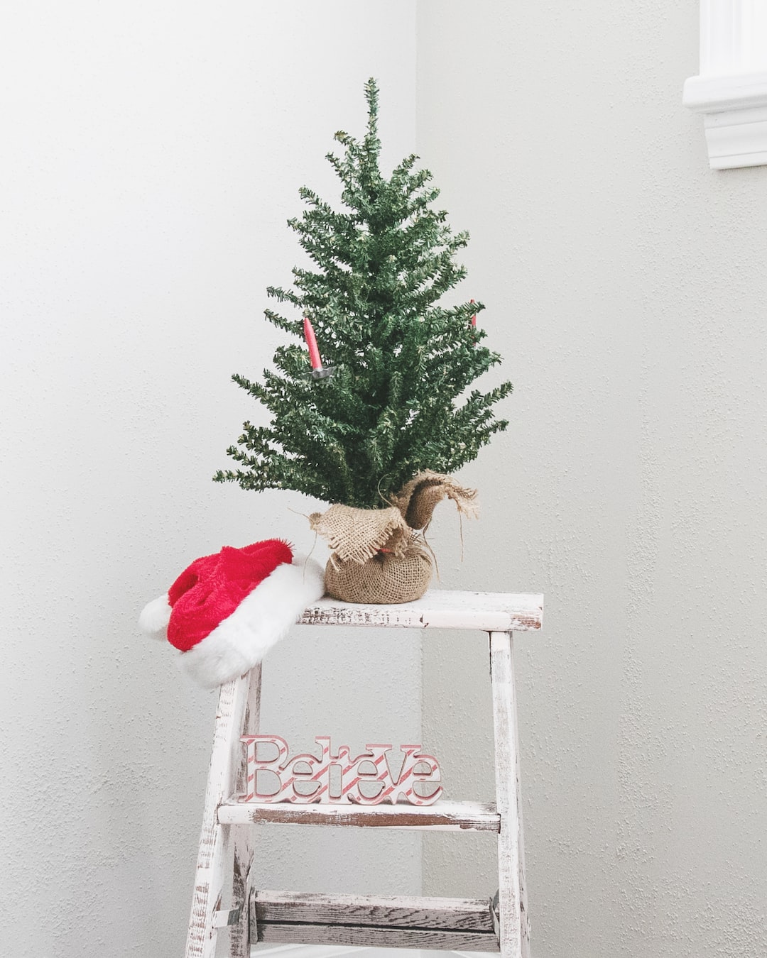 Mini Christmas tree on step stool with Santa's hat