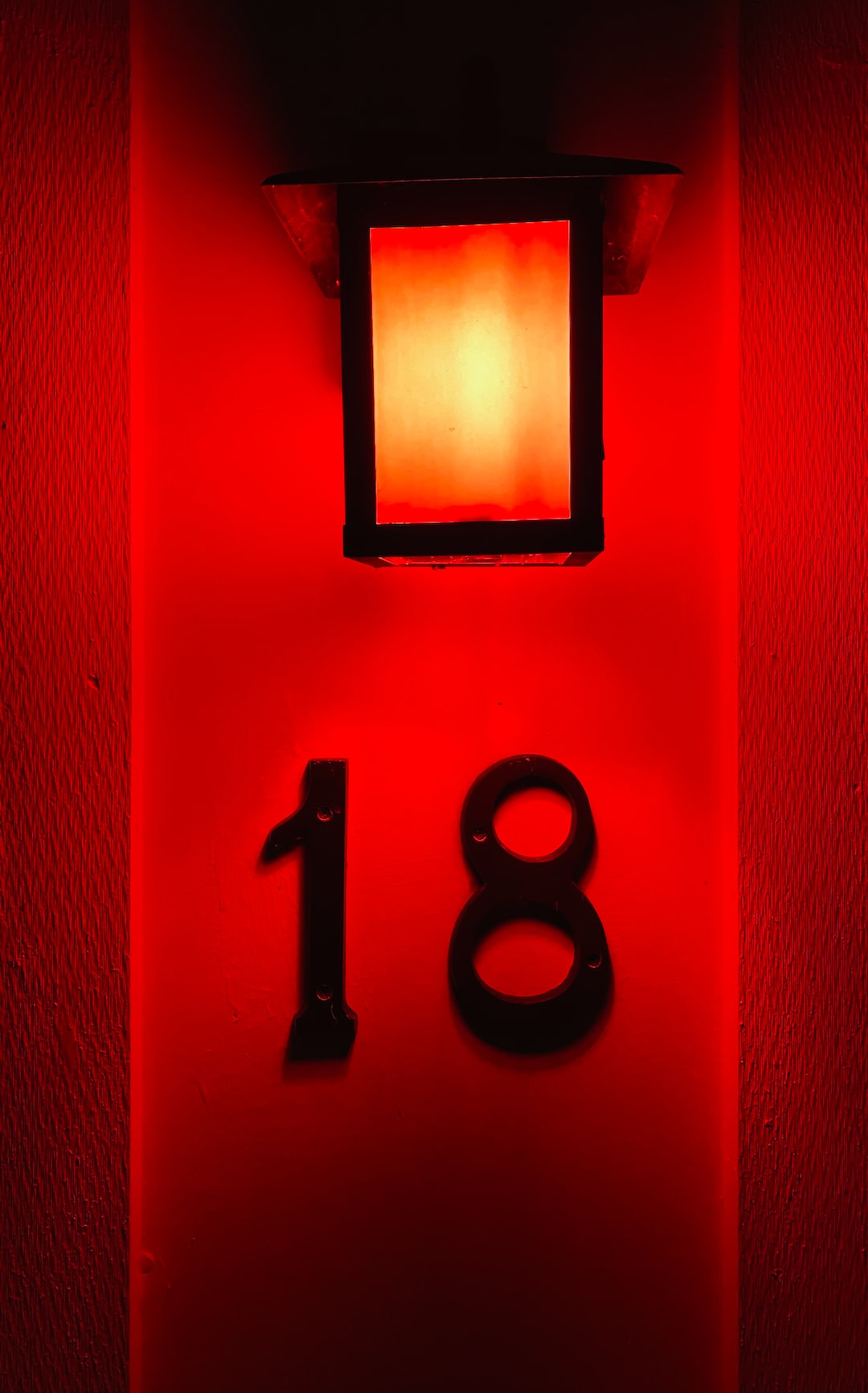 number eighteen illuminated by red light