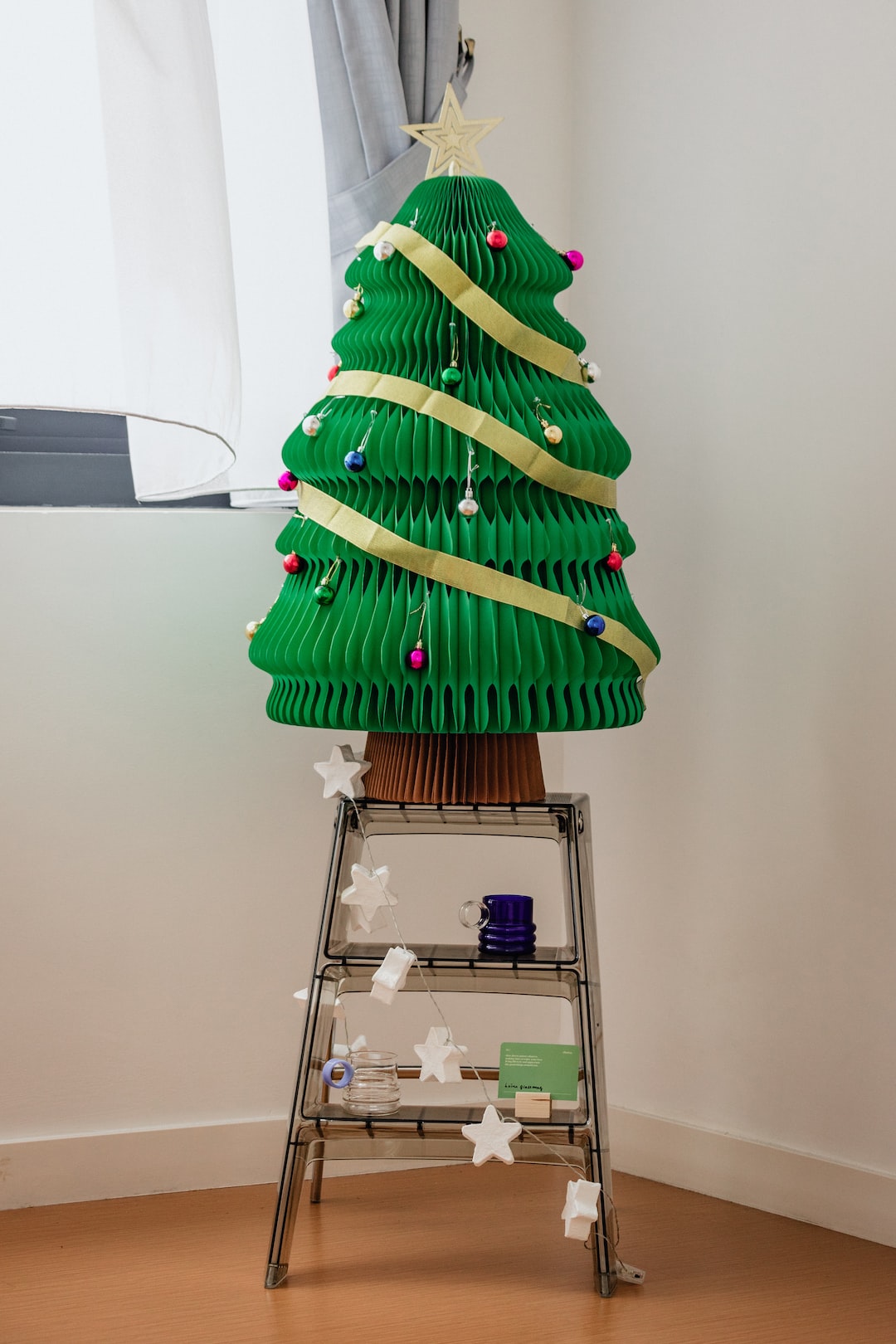 Christmas tree made of paper with decorations.