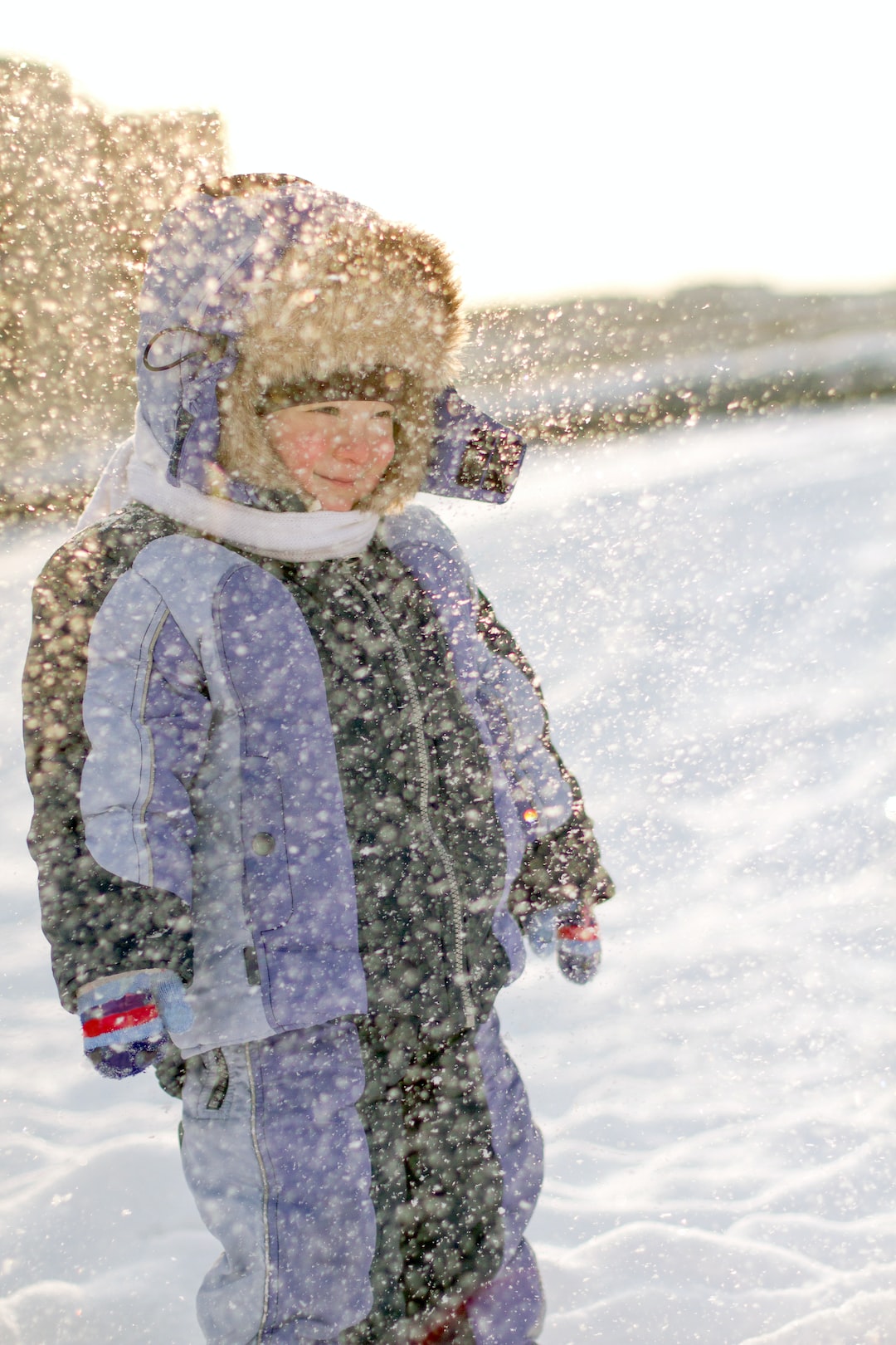 Boy is enjoying the first the snow. Waiting for the Cristmas