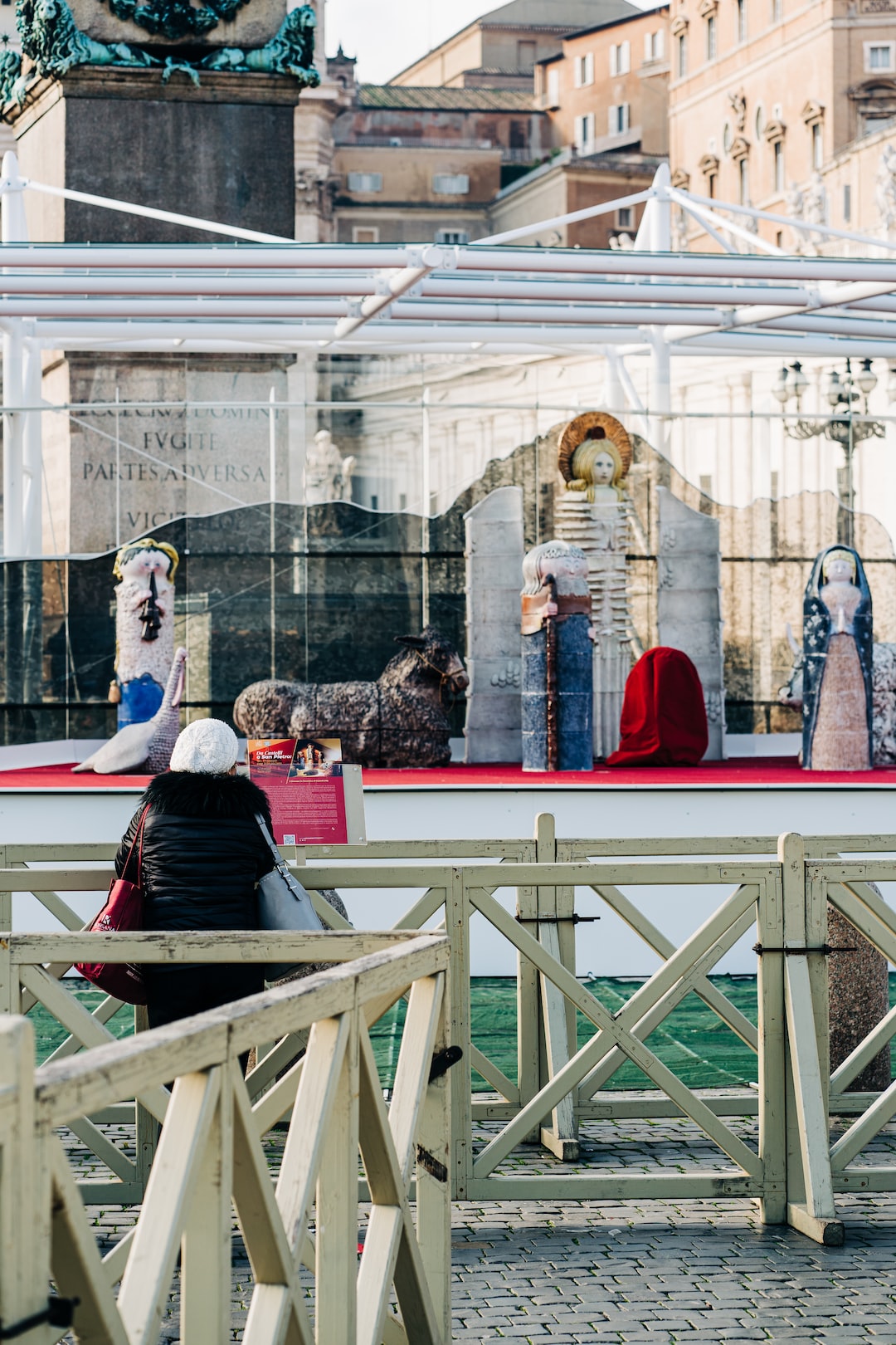 A woman prays for a better world in 2021 in front of the Nativity scene in St Peter's Square in the Vatican