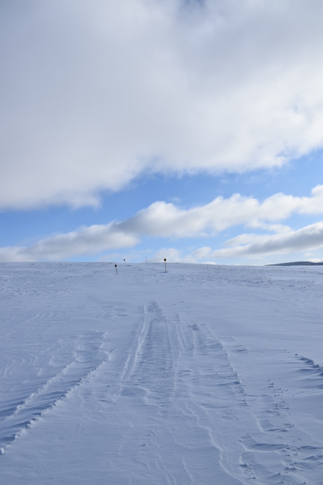 A snowmobile trail under a cloudy sky, Québec, Canada