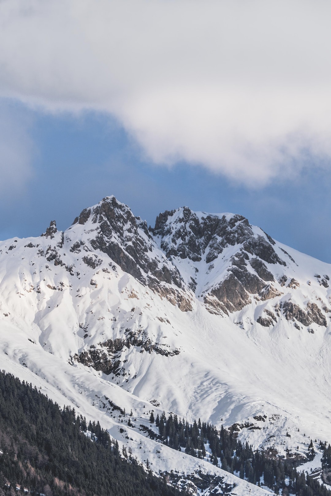 Clouds roll over the snow covered mountains of Innsbruck in Austria.