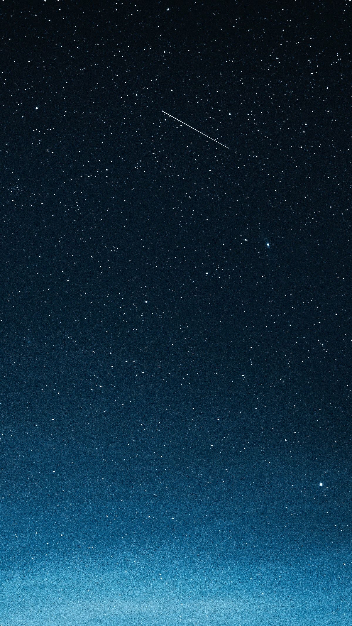 Download premium image of Shooting star in the dark blue sky over Greenland by Luke Stackpoole about iphone wallpaper shooting star night sky iphone wallpaper dark and heaven 2315381