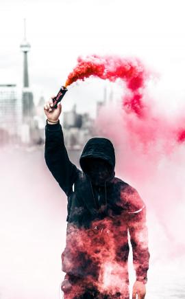 Person with pink smoke grenade