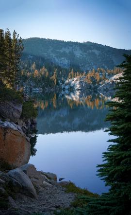 Reflective waters and clear golden hour lighting at Lake Fontanillis in Desolation Wilderness. Taken near Lake Tahoe, Sierra Nevadas, California.