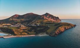 Landscape photo of oceanside mountain scenery at sunset