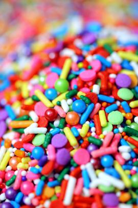 Colorful, vertical background of candy sprinkles.