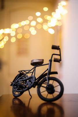 Miniature cycle on a table with bokeh background