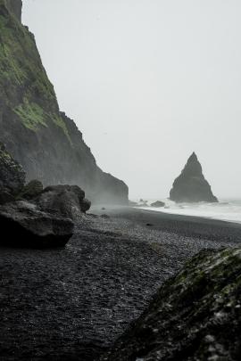 Surrounded by black sand, cliffs, rough sea, strong wind and rain. This place feels like the end of the world.
