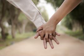 Engaged couple linking fingers
