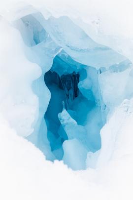 blue icy hole in snowbank