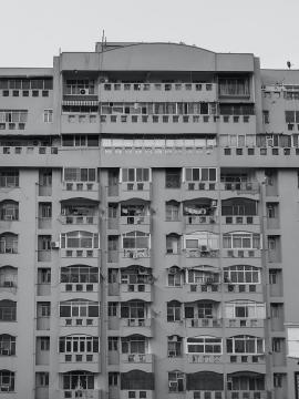 A black and white shot of buildings - apartments.