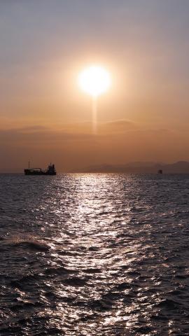 Evening sun glistening on the sea at Sai Wan Swimming Shed, Hong Kong