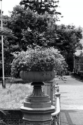 A stone flowerpot on a bridge