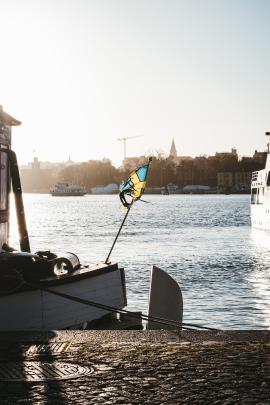 Sunrays through the Swedish flag on Strandvagen, Stockholm.
