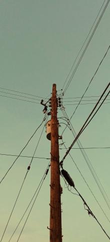 low angle of telephone pole against clear sky during sunset