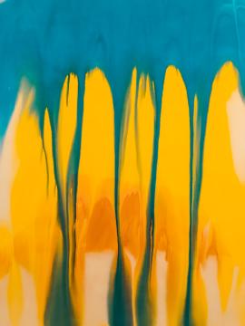 Blending watercolors blue and yellow to create orange and green on canvas