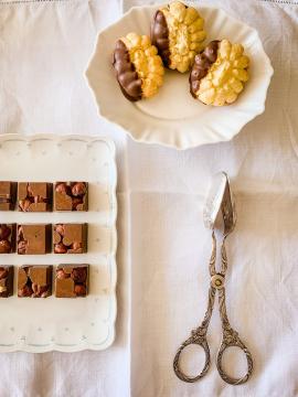 Teatime with fine selection of homemade nougat chocolate cookies and hazelnuts with milkchocolate