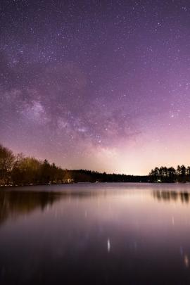 The Milky Way rises above a calm lake in a rural New England town. Despite the water not being frozen here, this was taken during the winter when my hands were freezing every time I pushed the shutter button.