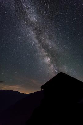 Shot on top of a mountain in Austria with a mountain cabin in the foreground.