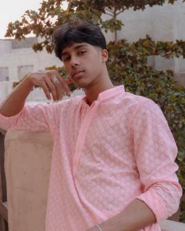 A picture of a boy wearing a Kurta during the festival of Diwali.