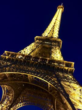 Eiffel Tower fully illuminated at night at Paris (France).