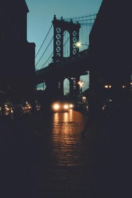 Cars' headlights at night by the bridge 