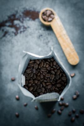 roasted coffee beans in a bag with a scoop