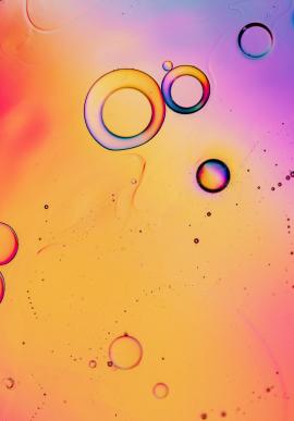 Oil drops and bubbles floating over water