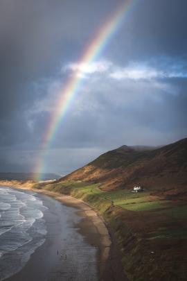 A stunning Rainbow breaking above the beach at Rhossilli in the Gower