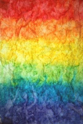 Textured paper watercolor paint rainbow background.