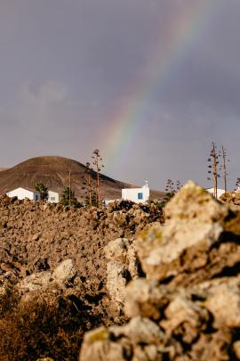 rainbow over a spanish town and the hills of fuerteventura