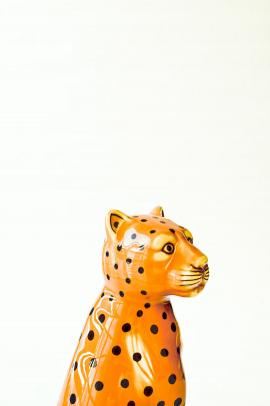 Leopard ceramic sculpture on white background