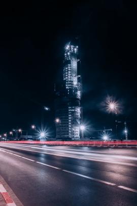 CITY THAT NEVER SLEEPS, A COOL SHOT OF BRIGHTING TOWER WITH LONG EXPOSURE ON THE STREET AT NIGHT