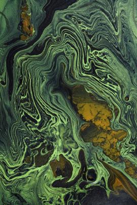 Green and gold turbulence on black canvas