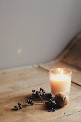 Candle on wooden table 