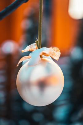 Christmas golden ball and tree branch. Christmas decorations.