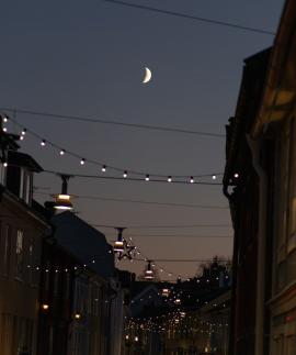 Waxing moon and christmas lights.