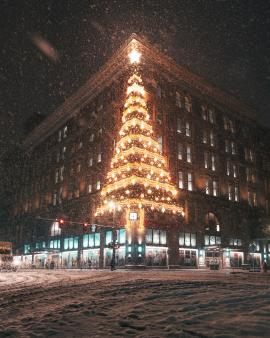 Christmas tree lights up the night sky during a snowstorm in downtown Pittsburgh, PA